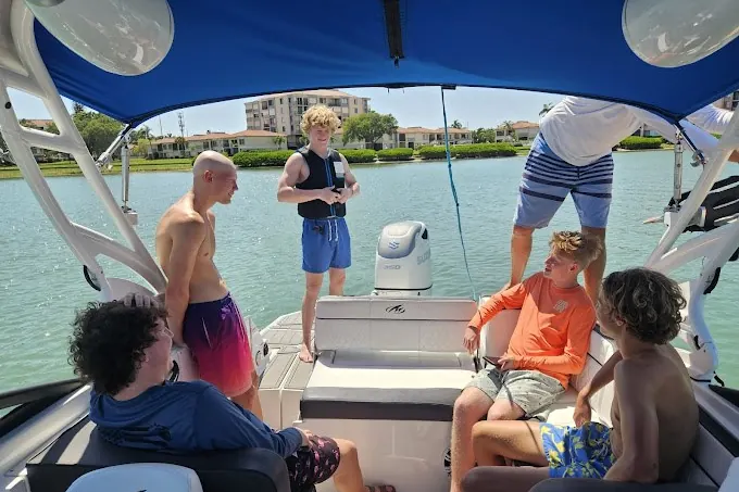 Small group of friends relaxing on a private boat in Tampa Bay