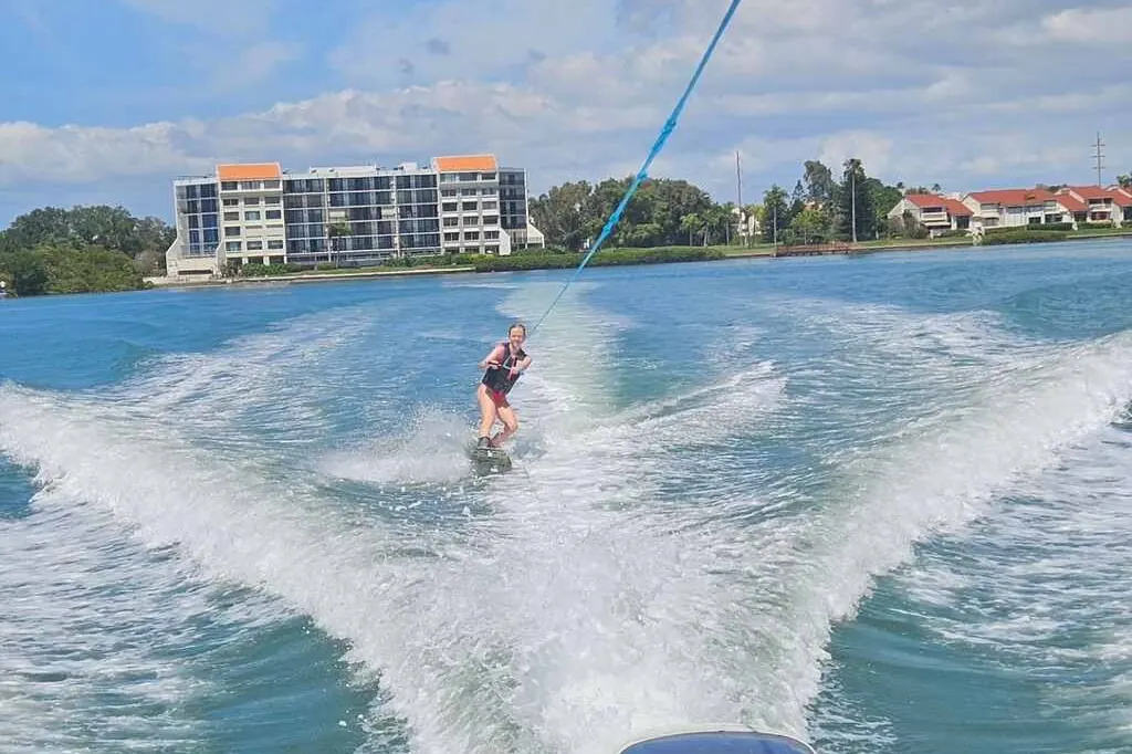 Young rider learning to wakeboard behind a boat in Gulfport