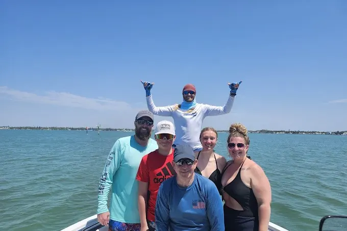 Parents and kids riding a tube behind a private boat