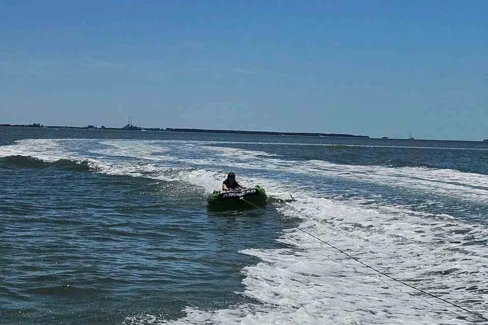 Friends tubing behind a boat on spring break near Gulfport