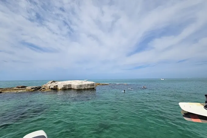 Pelican and clear water beside a boat near Treasure Island